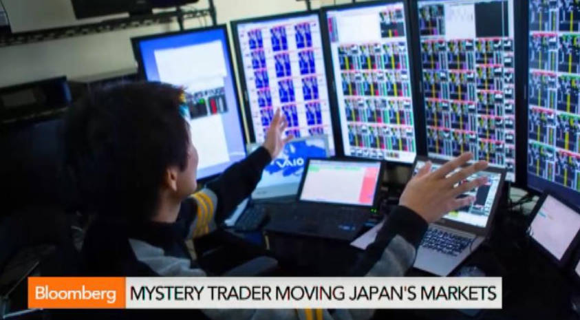 Takashi Kotegawa seen with his trading setup of 5 monitors and multiple devices and tablets. - Ultima Markets